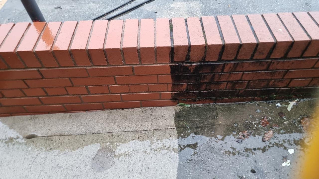 Halfway along a brick wall: same wall, both sides