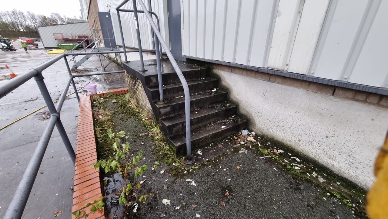 Before: moss, weeds and silt against the building