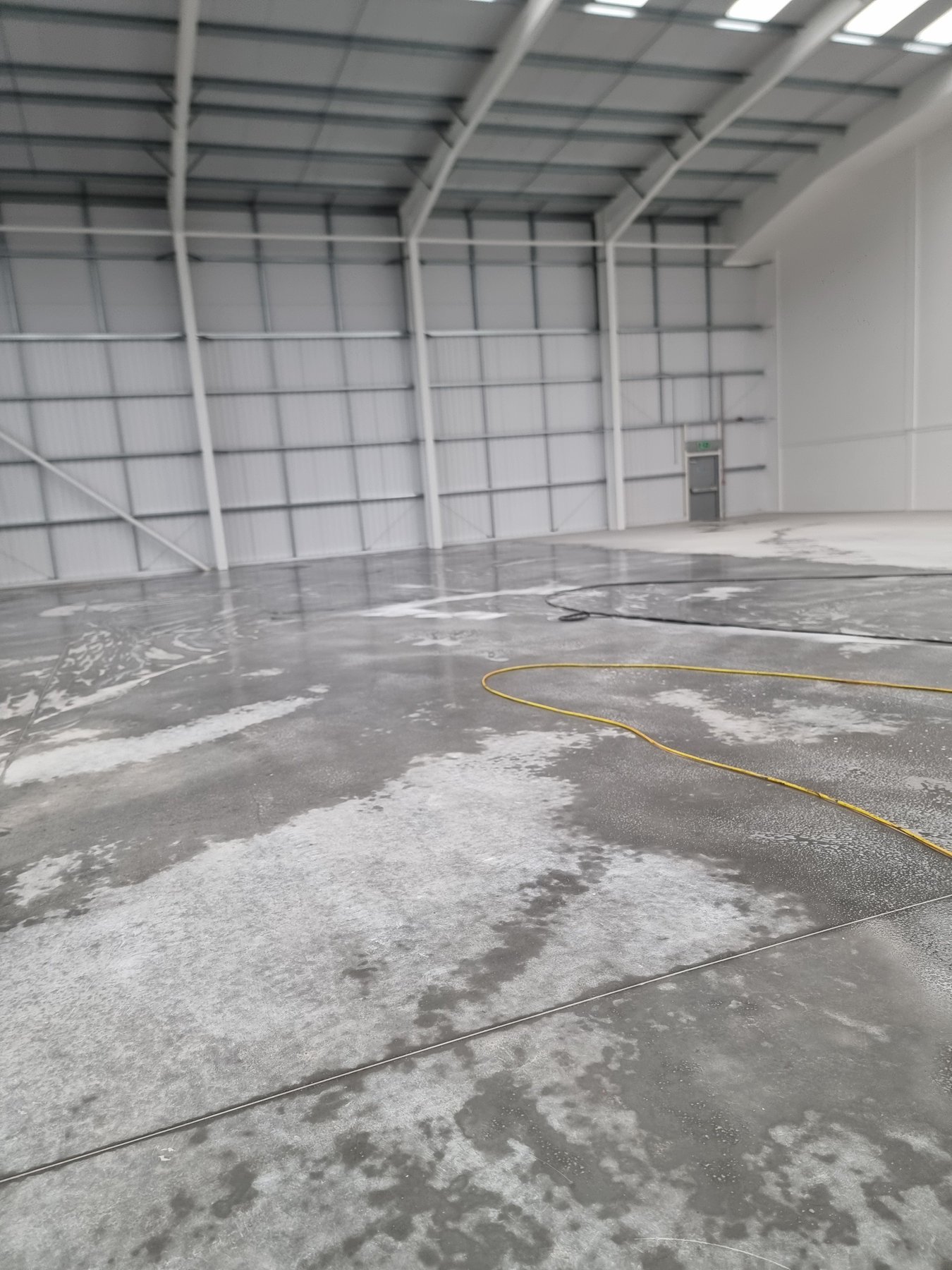 Warehouse floor being scrubbed before handover